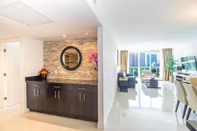 a living room with a mirror on a brick wall at Ocean Reserve 818 in Miami Beach