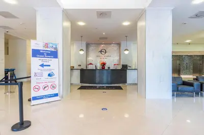 a lobby with a sign in the middle of a building at Ocean Reserve 818 in Miami Beach
