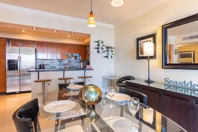 a dining room with a glass table and chairs at Ocean Reserve 1515 in Miami Beach