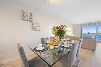 a dining room with a glass table and chairs at Golden Bay 509 in Miami Beach