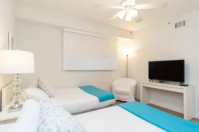 a bedroom with a bed and a flat screen tv at Golden Bay 602 in Miami Beach
