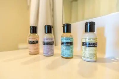 three bottles of hair products sitting on a table at Golden Bay 302 in Miami Beach