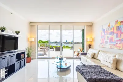 a living room with a couch and a tv at Golden Bay 303 in Miami Beach