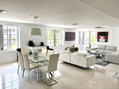 a living room with white furniture and a glass table at WOW! Best Location! Best Unit! New Renovated South Beach Ocean Front in Miami Beach