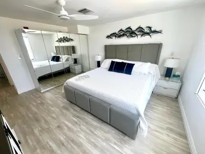 a bedroom with a large bed and a mirror at WOW! Best Location! Best Unit! New Renovated South Beach Ocean Front in Miami Beach