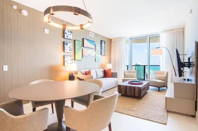 a living room with a table and a couch at Lyfe Beach Resort 3604 in Hollywood Beach