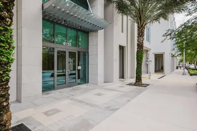 a sidewalk in front of a building with a palm tree at Coral Gables 1BR w WD Pool Gym nr Shops MIA-9 in Miami