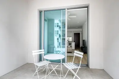 a table and chairs in a room with glass doors at Coral Gables 1BR w WD Pool Gym nr Shops MIA-9 in Miami
