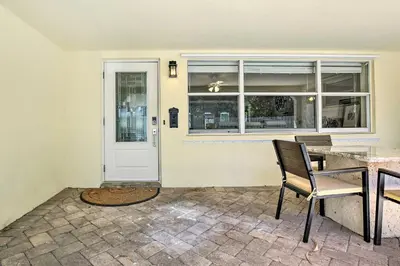 a dining room with a table and chairs and a door at Vacation Rental with Private Pool in Wilton Manors in Fort Lauderdale