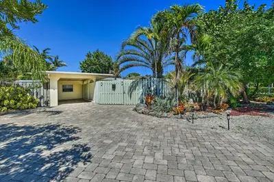 a house with a fence and a driveway at Vacation Rental with Private Pool in Wilton Manors in Fort Lauderdale