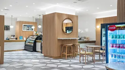 a fast food restaurant with a counter and stools in a store at 1 Bedroom Private Residence at Carillon Miami Resort -911 in Miami Beach