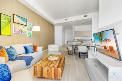 a living room with a couch and a table at Beachfront Condo Front Oceanview Balcony Pools in Hollywood