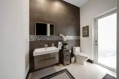 a bathroom with a sink and a toilet at Luxury home w pool by PMI in Miami