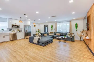 a living room with two couches and a kitchen at Fox Garden-Heated Pool-Spa- Boho-Downtown & Beach in Fort Lauderdale