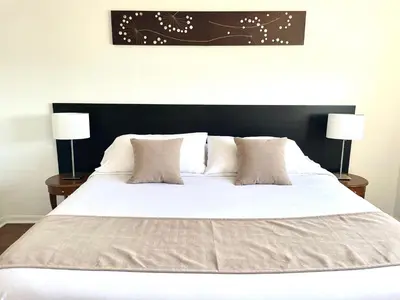 a large white bed with two nightstands and two lamps at Beautiful Apartment in Sunny Isles STR-01432 in Miami Beach