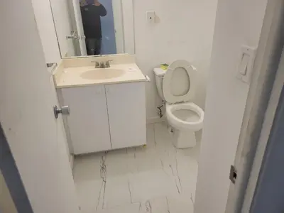 a white bathroom with a sink and a toilet at Beautiful Apartment in Sunny Isles STR-01432 in Miami Beach