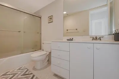 a white bathroom with a toilet and a sink at Beautiful Apartment in Sunny Isles STR-01432 in Miami Beach