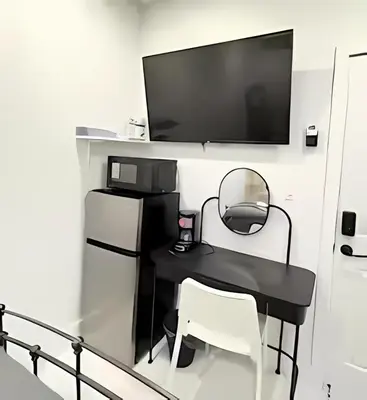 a black table with two chairs and a television on a wall at Private Rooms close to Miami Airport - Free parking - 02 in Miami
