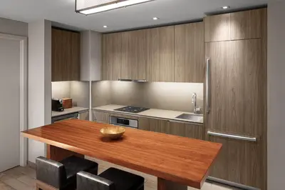 a kitchen with a wooden table and a refrigerator at EAST Miami Residences in Miami