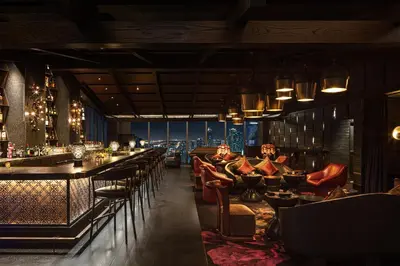 a restaurant with a bar with a view of the city at EAST Miami Residences in Miami