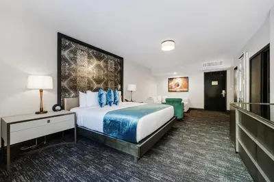 a hotel room with a large bed and a couch at Venezia Hotel By At Mine Hospitality in Miami Beach