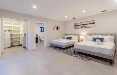 a bedroom with two beds and a walk in closet at Mega Fun Villa Northwest Miami BY THE GLAMHOMES in Miami