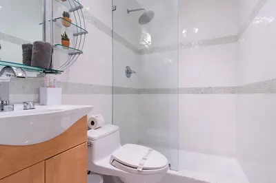 a bathroom with a shower and a toilet and a sink at Cool Villa Northwest Miami BY THE GLAMHOMES in Miami