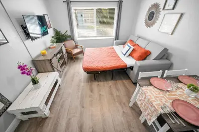 a small living room with a couch and a table at The Leeward Apartments By Lowkl in Fort Lauderdale