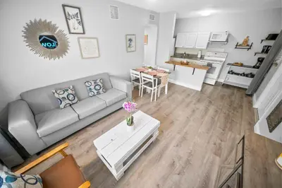 a living room with a couch and a table at The Leeward Apartments By Lowkl in Fort Lauderdale