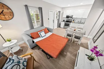a living room with a couch and a table at The Leeward Apartments By Lowkl in Fort Lauderdale