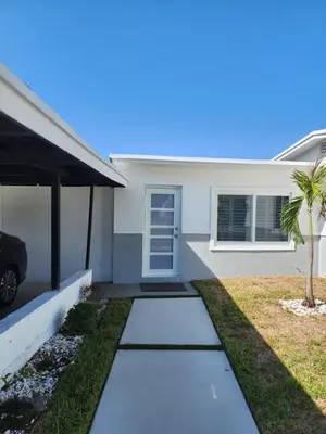 a house with a palm tree in front of it at JBMANORS in Fort Lauderdale