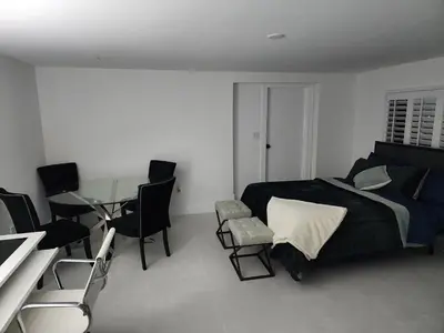 a bedroom with a bed and a table and chairs at JBMANORS in Fort Lauderdale