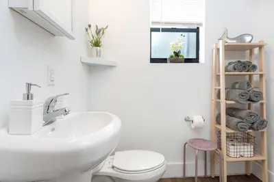 a bathroom with a white sink and a toilet at Lovely Apartment Near Brickell 1 in Miami