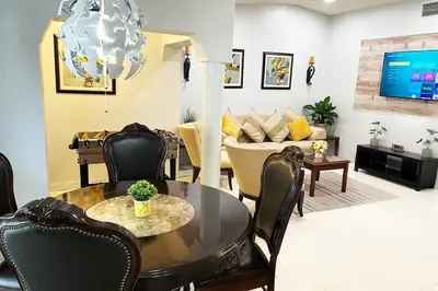 a living room with a table and chairs and a couch at Amazing & cozy Duplex near Zoo Miami ! in Miami