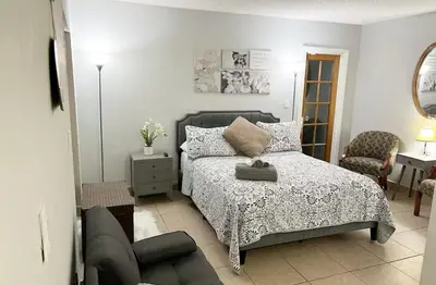 a small bedroom with a bed and a chair at Amazing & cozy Duplex near Zoo Miami ! in Miami