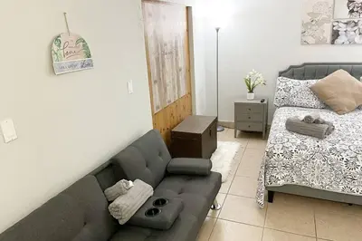 a living room with a couch and a bed at Amazing & cozy Duplex near Zoo Miami ! in Miami