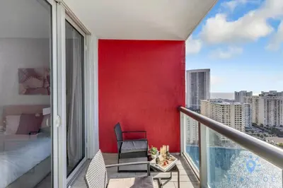a balcony with a red accent wall and a bedroom at Apartment w Balcony Gym Near Beach in Hallandale Beach