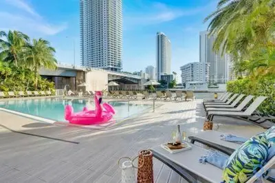 a swimming pool with a pink flamingo in a city at Apartment w Balcony Gym Near Beach in Hallandale Beach