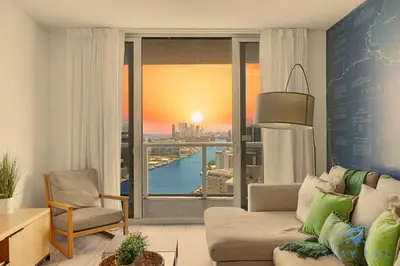 a living room with a view of a city at Infinite View Balcony Pool Gym in Hallandale Beach