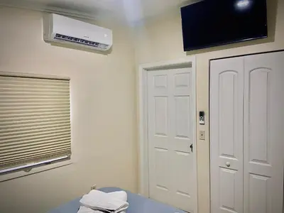 a room with a window and a air conditioner on the wall at Private Room near Miami Airport - Free parking - 02 in Miami