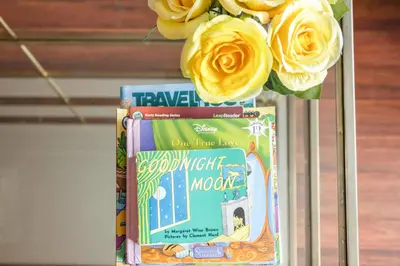 a vase of flowers on top of some books at Brickell Apt with Bay Views, Pool, Free Parking in Miami