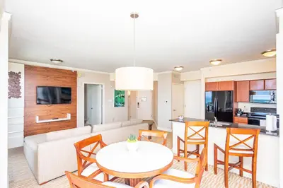 a kitchen and living room with a table and chairs at TRUMP INTERNATIONAL BEACH RESORT 2 BEDROOM APARTMENT 1600 Sf Ocean and Bay View in Miami Beach