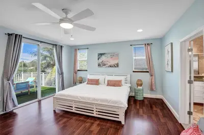 a bedroom with a bed and a ceiling fan at Water Front Home with Boat Dock Hot Tub Roof Top Fire Pit in Fort Lauderdale