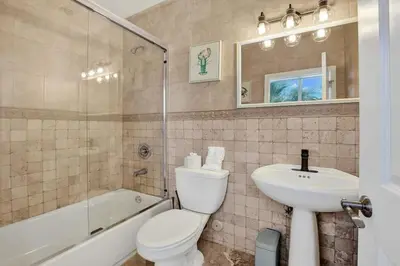 a bathroom with a toilet and a sink and a tub at Water Front Home with Boat Dock Hot Tub Roof Top Fire Pit in Fort Lauderdale