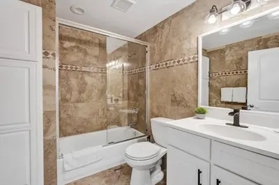 a bathroom with a toilet and a shower and a sink at Water Front Home with Boat Dock Hot Tub Roof Top Fire Pit in Fort Lauderdale