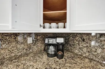 a kitchen counter with a coffee maker in a cupboard at Water Front Home with Boat Dock Hot Tub Roof Top Fire Pit in Fort Lauderdale