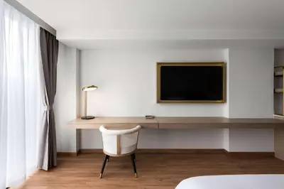 a room with a desk with a tv and a chair at Dolce by Wyndham Hollywood in Hollywood