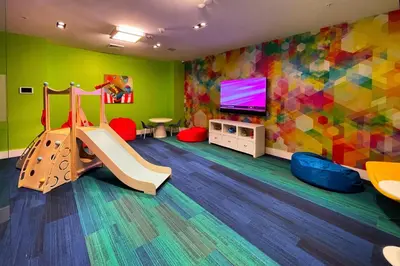 a childrens play room with a slide and a tv at Little Havana 1br w pool gym near restaurants MIA-48 in Miami