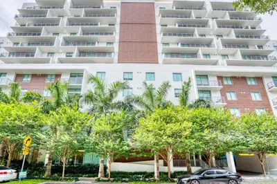 a large apartment building with trees in front of it at Little Havana 1br w pool gym near restaurants MIA-48 in Miami