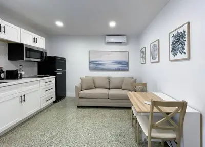 a kitchen and living room with a couch and a table at Private King Suite in Miami in Miami